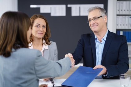 Businesswoman and businessman shaking hands