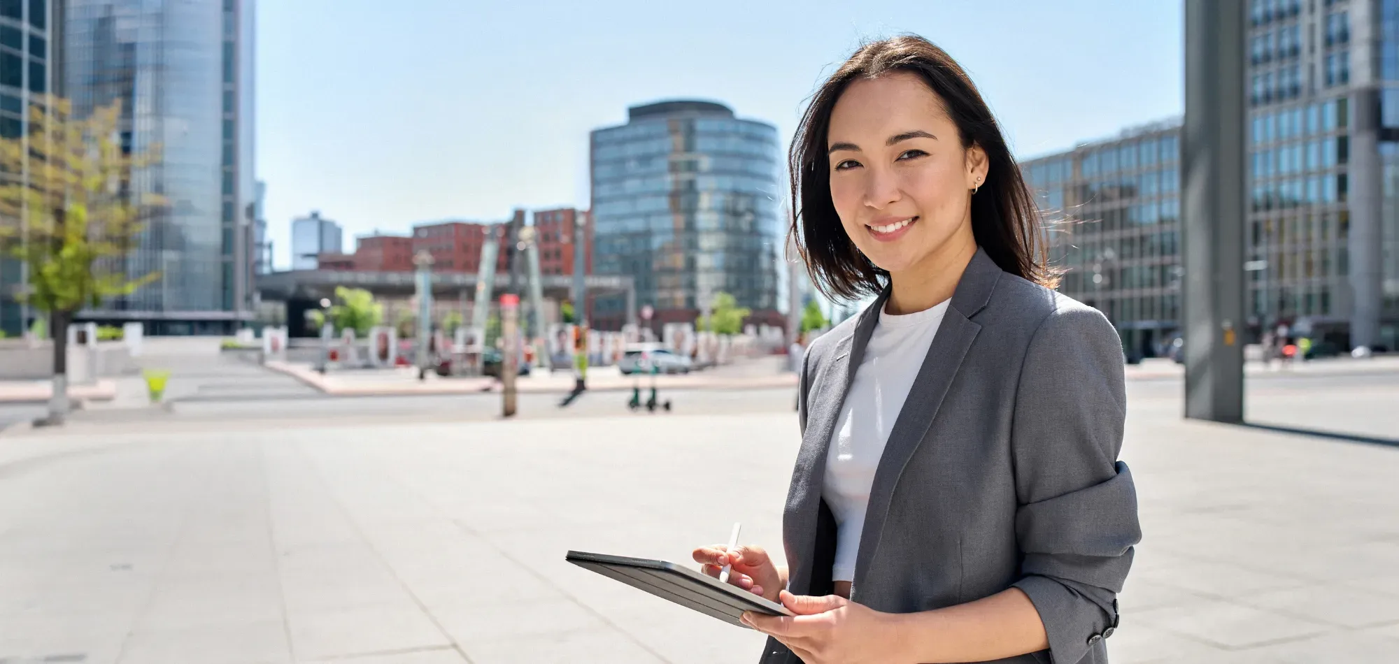 Smiling businesswoman cityscape background Banner Image