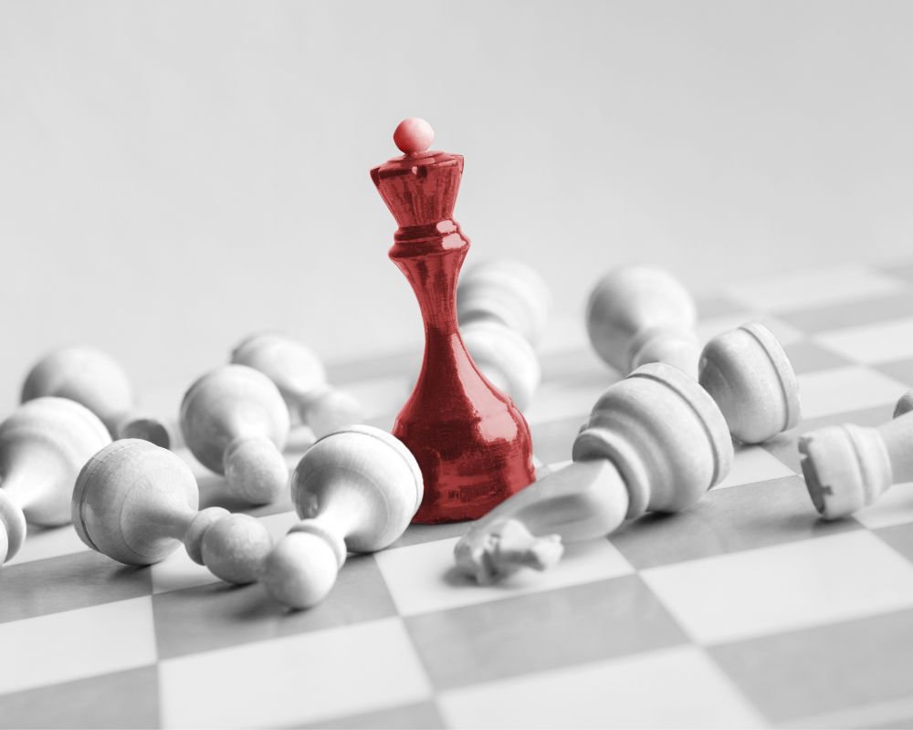 Red queen piece on a chess board