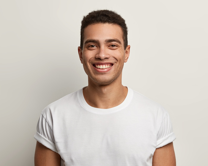 Short Dark Hair Young Smiling Man White Top Portrait 2