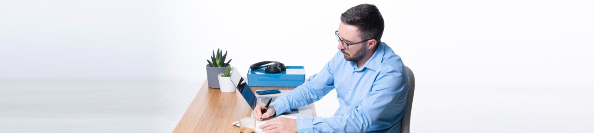 Recruitment consultant at a desk using a laptop or writing