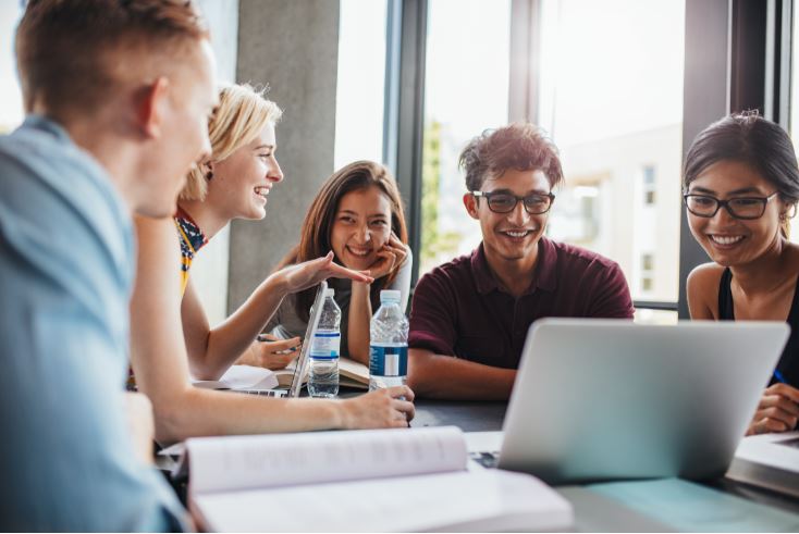 Relaxed Business Team Around Laptop