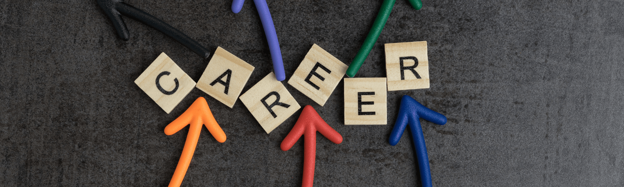 Colored arrows pointing to a wooden block with ‘Career’ text, symbolizing career direction and growth on a black background.