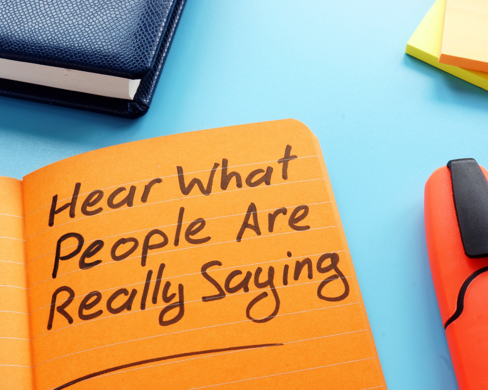 Hear what people are saying written in a notebook