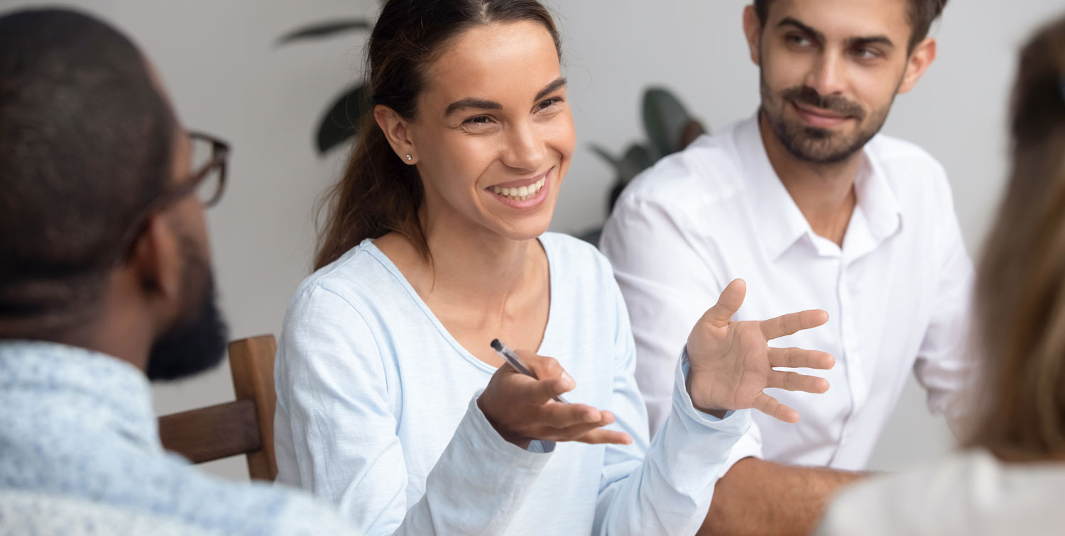 Brunette Smiling Explaining Open Arms With Team Clear Picture White Top