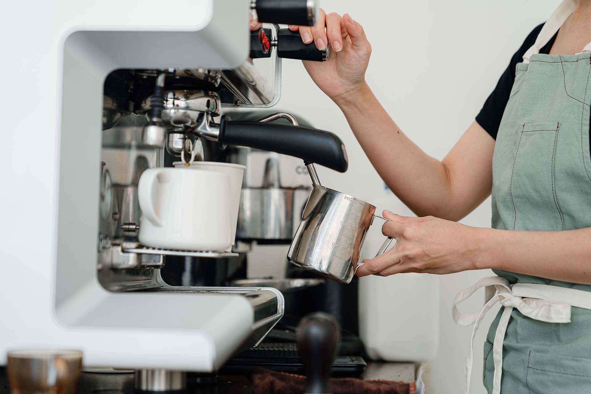 Barista Operating Industrial Coffee Machine