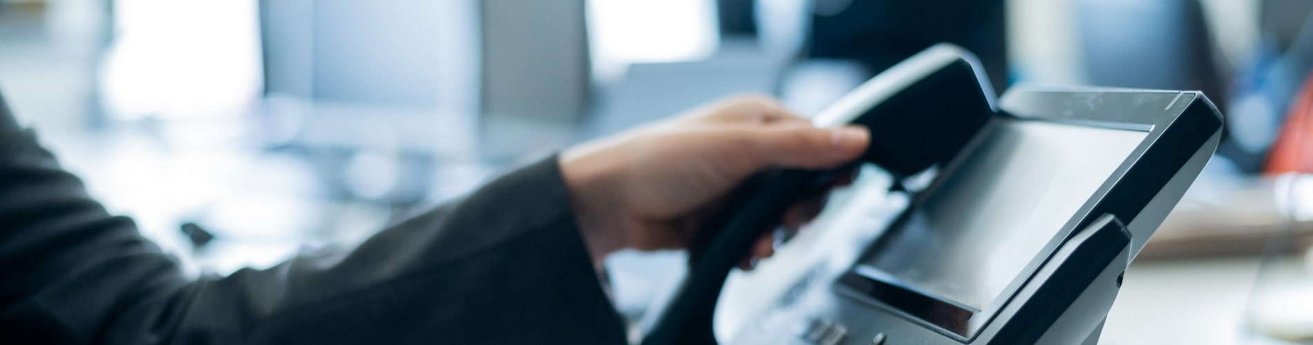 Receptionist picking up office phone