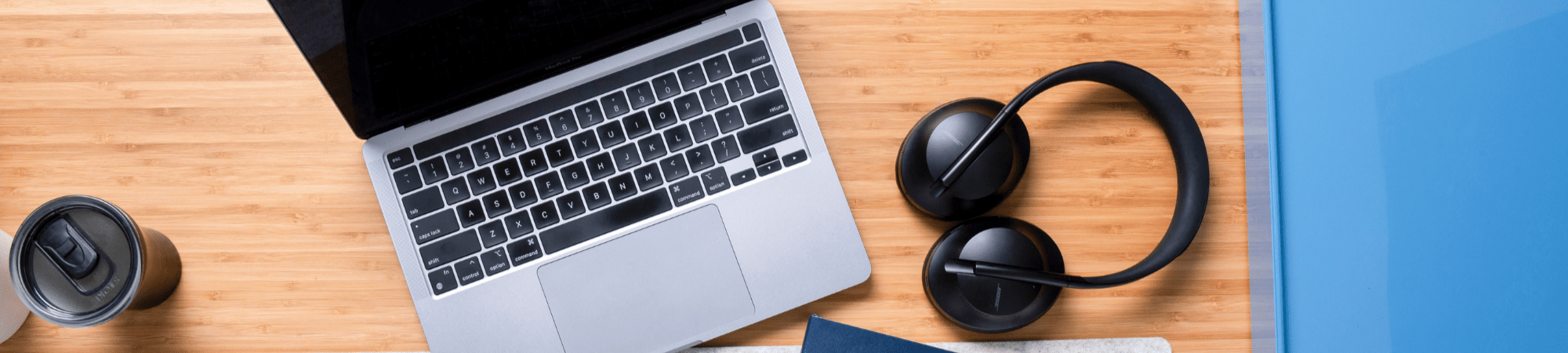 Laptop and headphones on a desk for vlogging