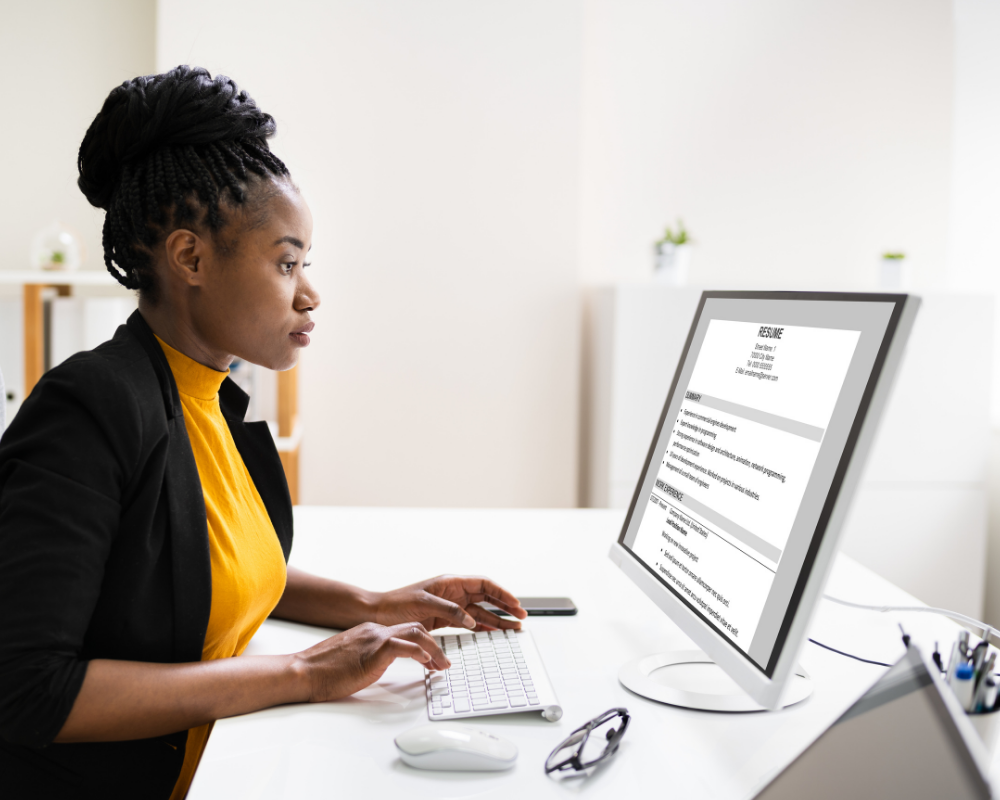 Woman updating her resume on a computer