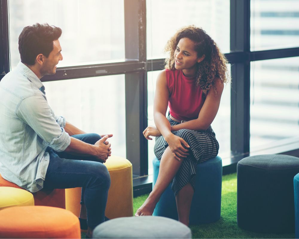 two people sitting and talking