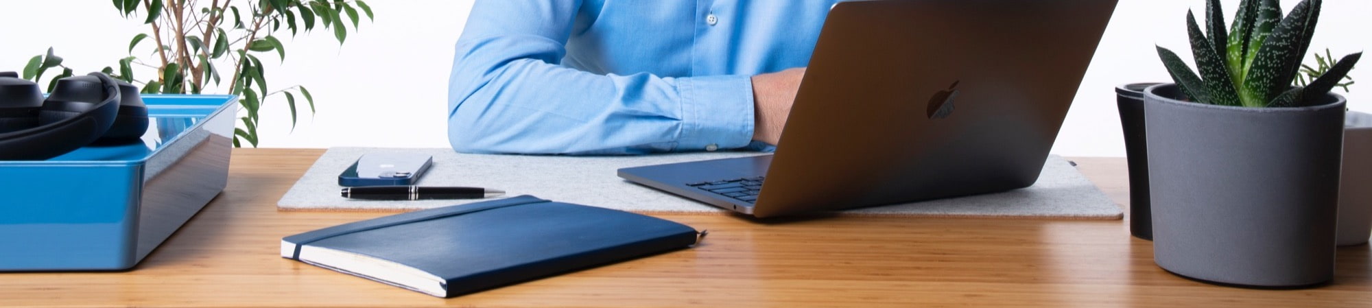Richard Duke, founder of DukeMed, seated at a desk with an open laptop, looking directly at the camera. A professional setting reflecting his expertise in MedTech executive search and recruitment.