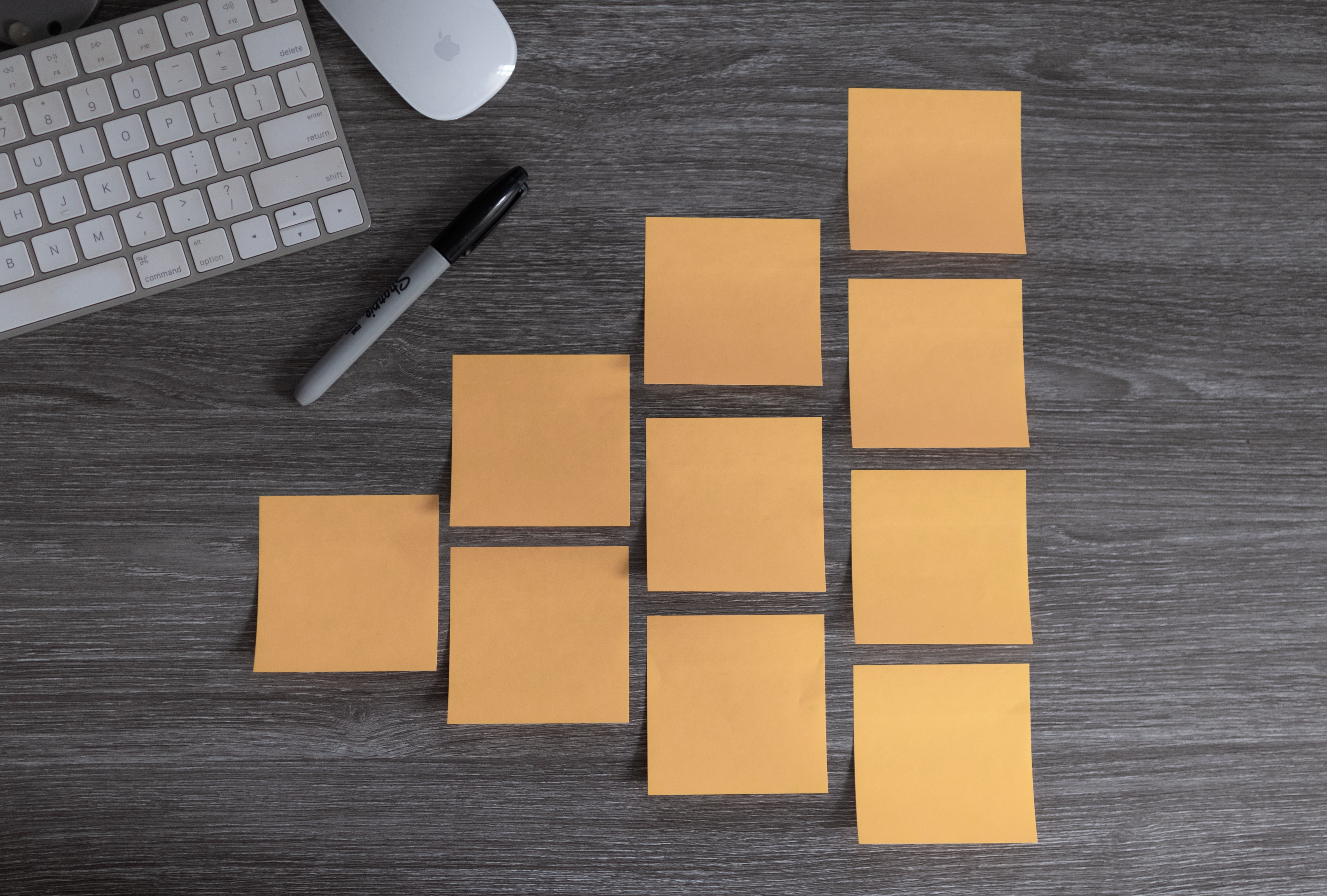 Blank Post-it notes on grey wood desk