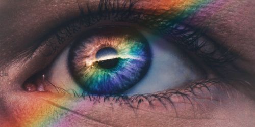 Close up of eye with rainbow reflection