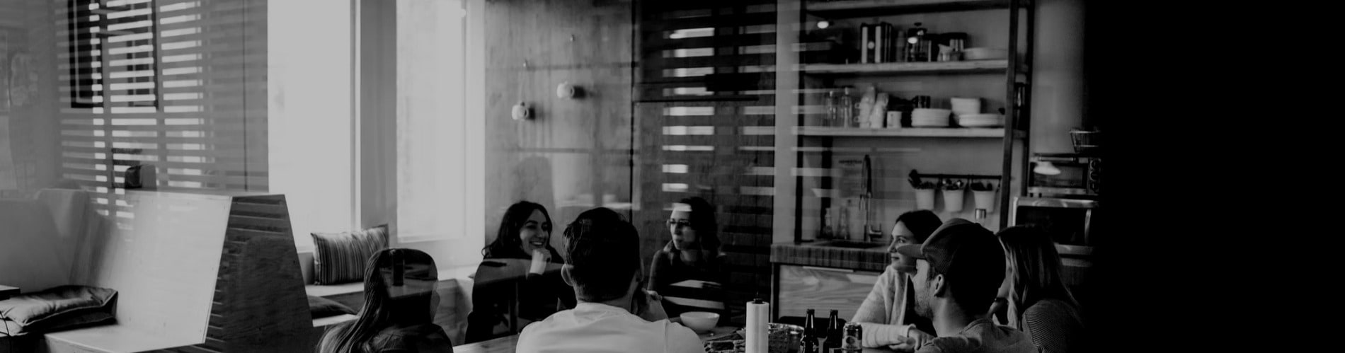 Coworkers eating at the kitchen office during lunch break