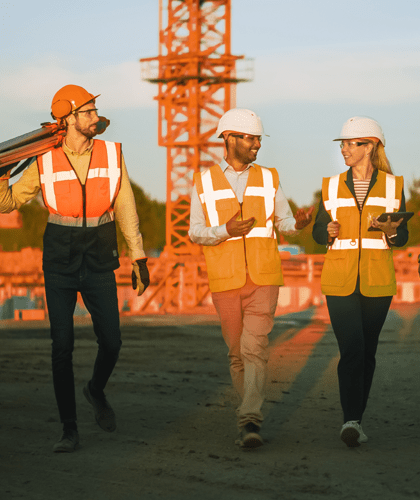 Woman consulting site workers on safety best practices