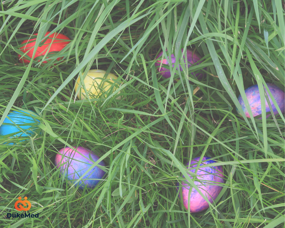 Colorful Easter eggs hidden in green grass, representing the challenge of searching for top talent in the hiring process