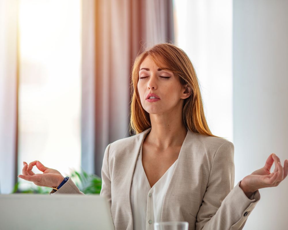 Women meditating at a desk