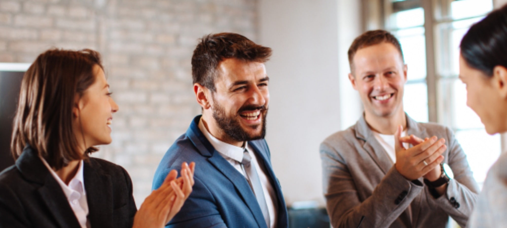 Happy employees clapping and cheering for each other