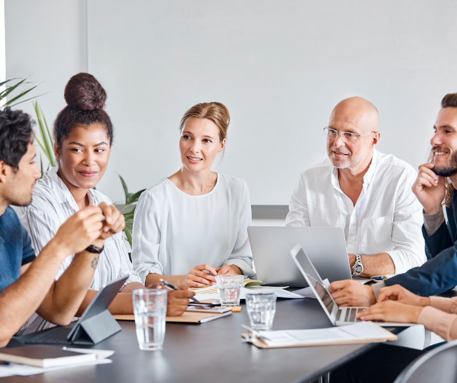 Mid-career professional leading a business meeting focused on leadership growth