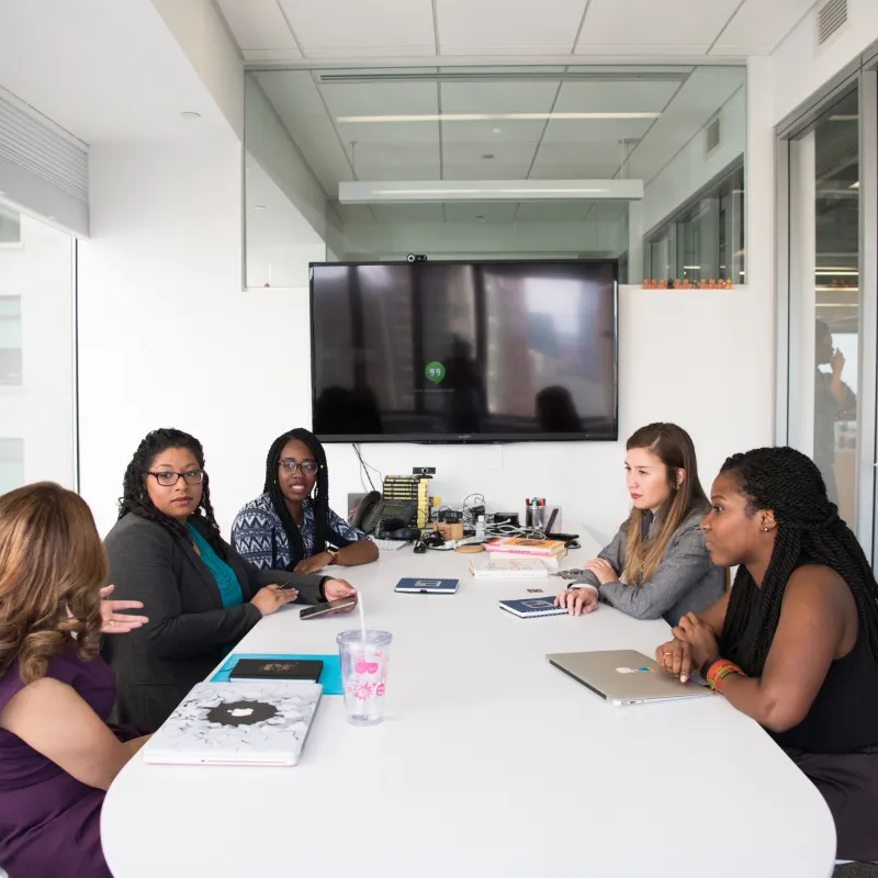 Diverse group female corporates in a boardroom