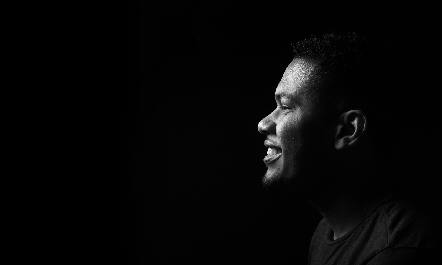 Man Afro Hairstyle Portrait Side Facing Smiling