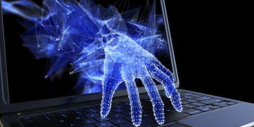 Cyber hand reaching out from computer screen