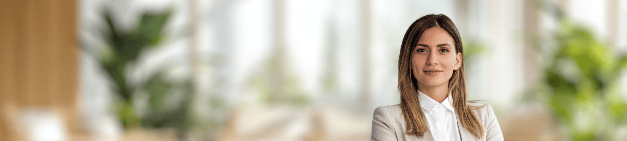 Smiling female professional wearing white button up shirt. 