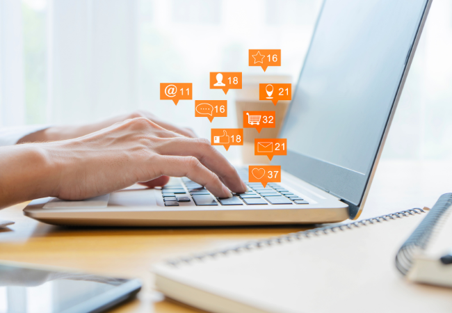 Two hands typing on laptop.