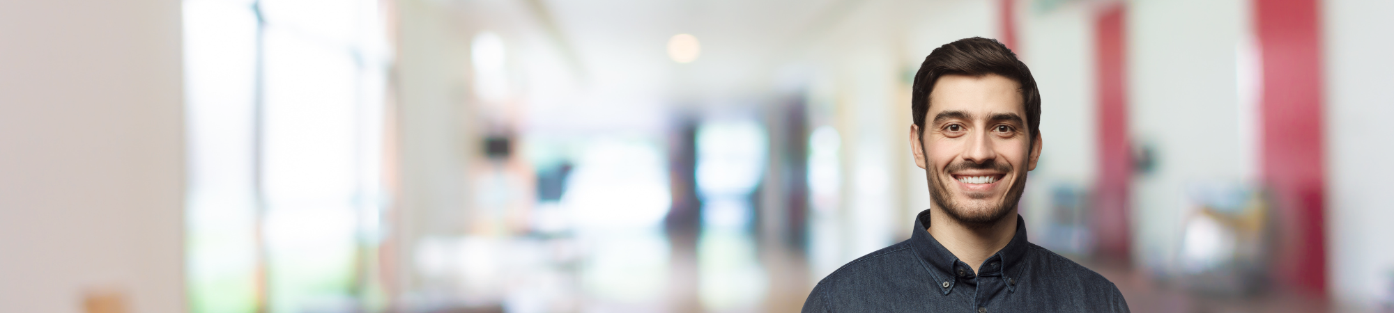 Young male professional wearing grey shirt. 
