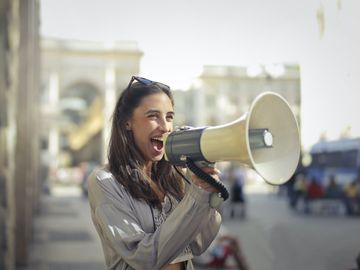 Woman shouting out on loudspeaker