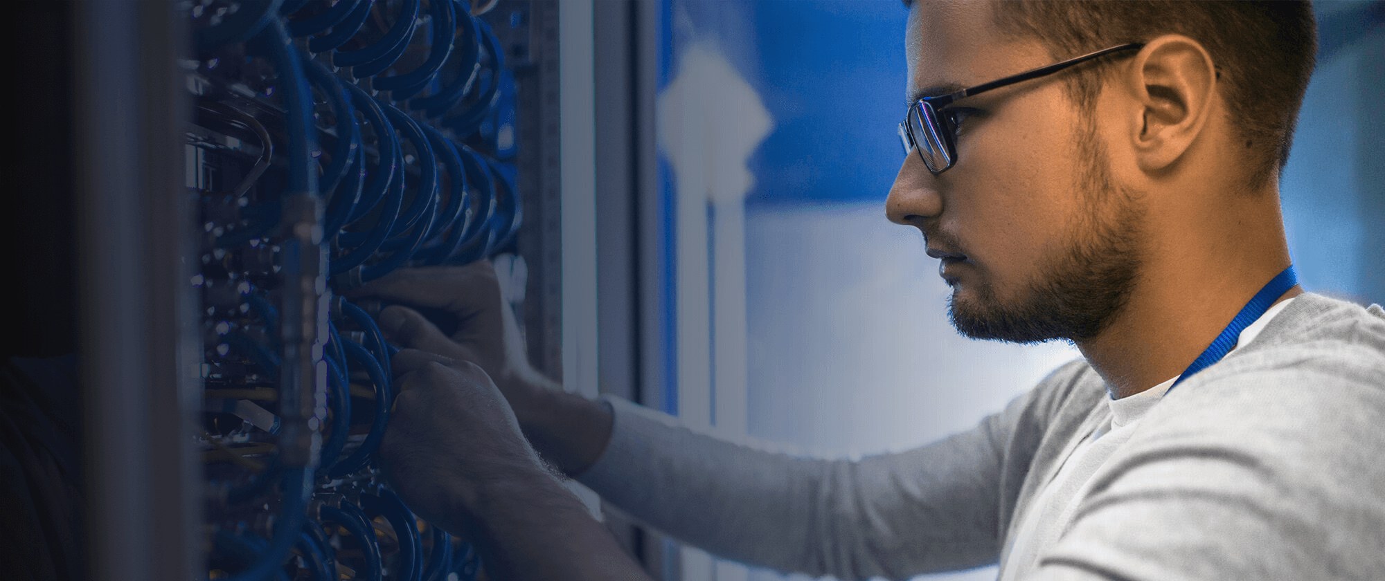 Focused technician meticulously managing server hardware in a data center.