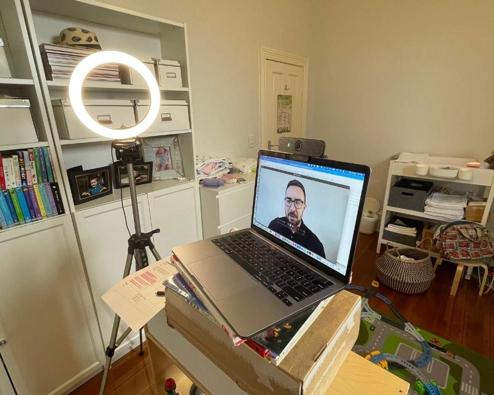 Laptop and ring light set up in an office.