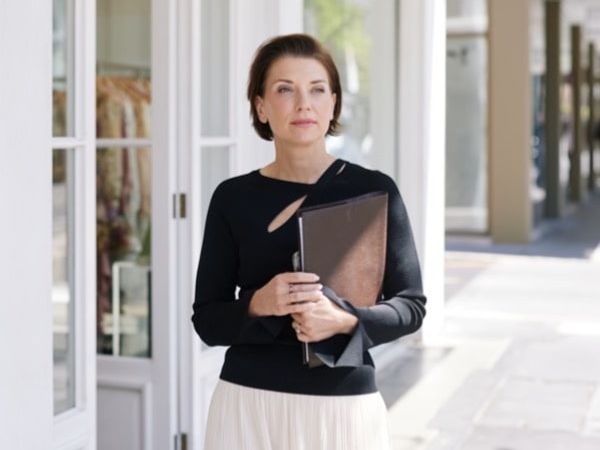 Founder and Director of ROUSSOS Recruitment, Anna Roussos, walking down Rundle Street with folders in hand on her way to a client meeting