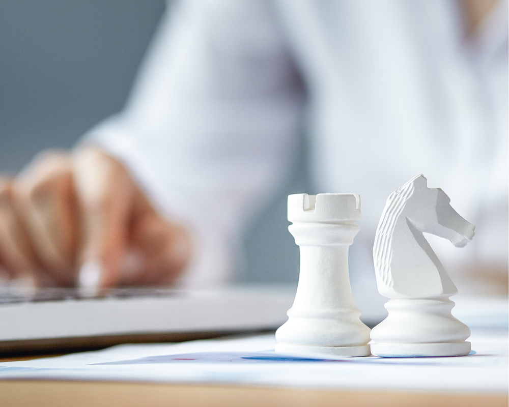 chess pieces and person strategising