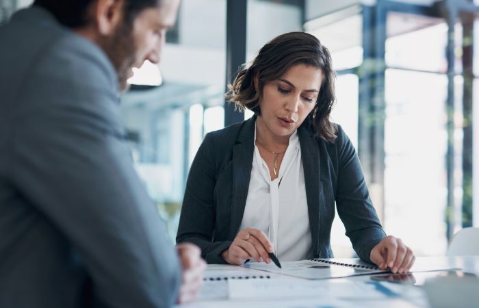 Two employees reviewing a business proposal