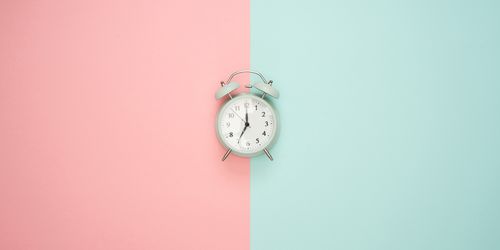 Clock in front of multicoloured background