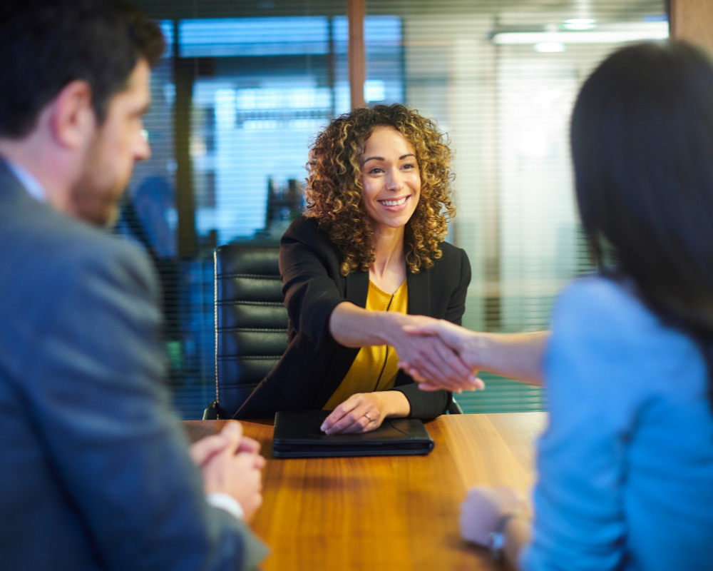 Woman shaking hands after at an interview