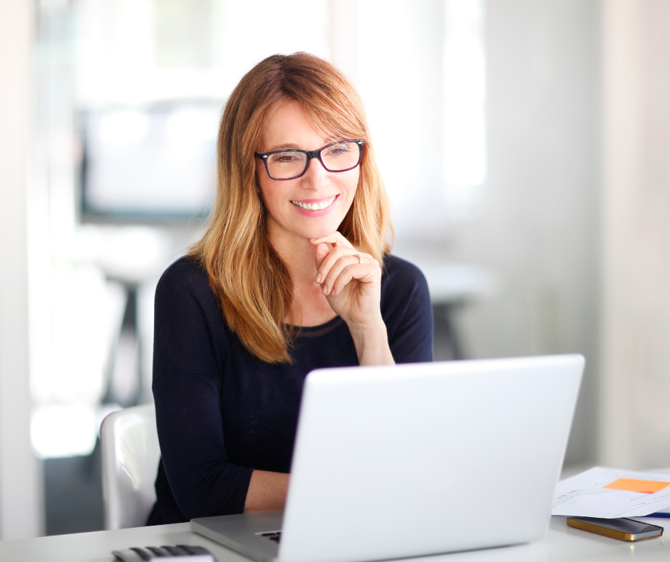 Employer strategising leadership hiring at desk with laptop and notes