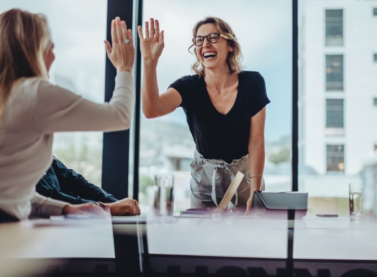 Two ladies high fiving