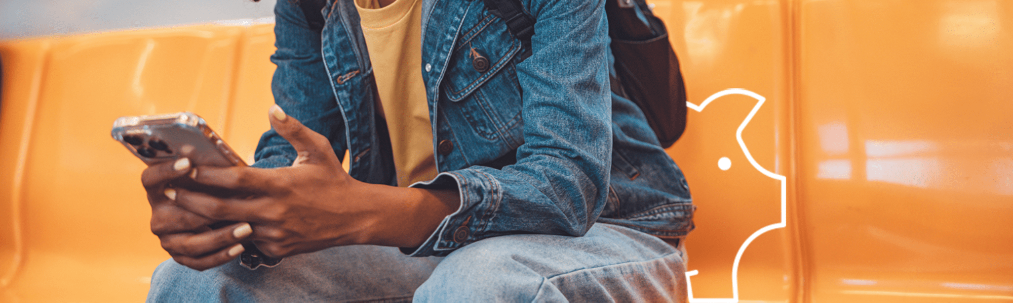 Woman of colour sitting on train looking at phone smiling