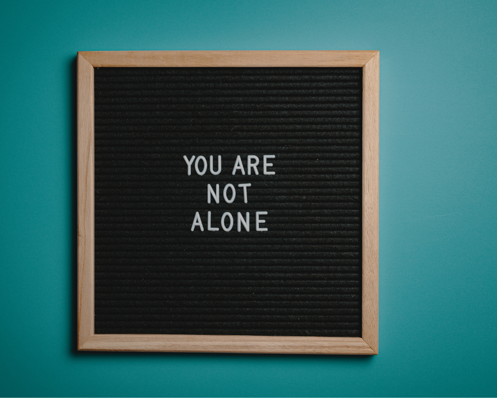  a black board with the words You are not alone 