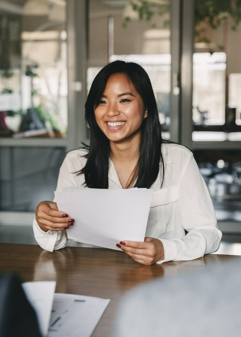 Lady smiling in an office meeting room