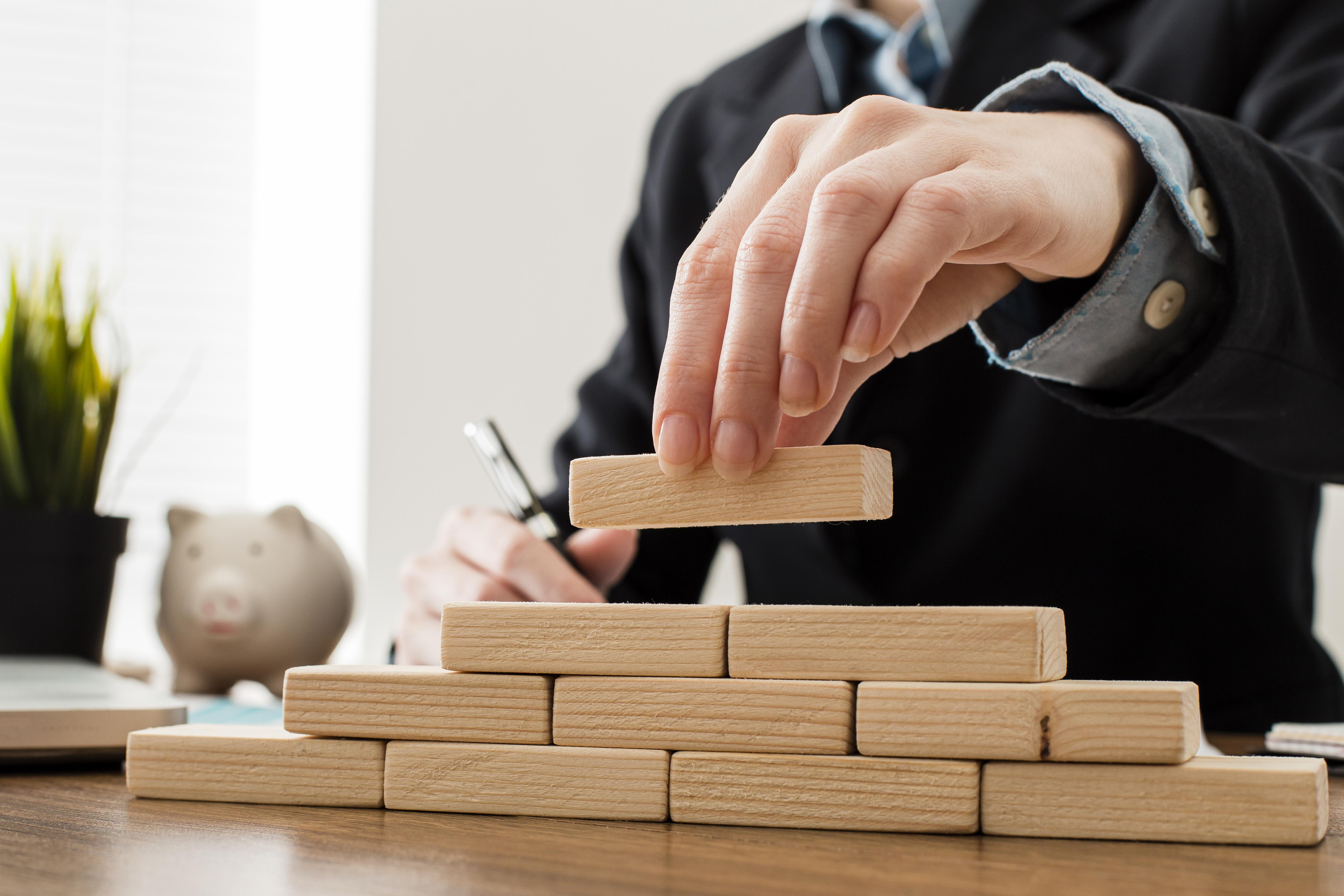 Front View Businessman With Wooden Building Blocks