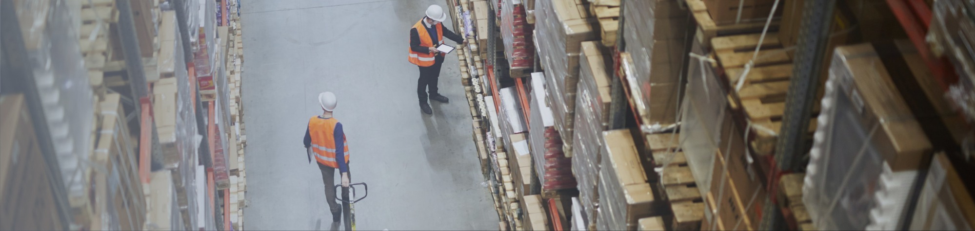 Two workers in a logistics facility