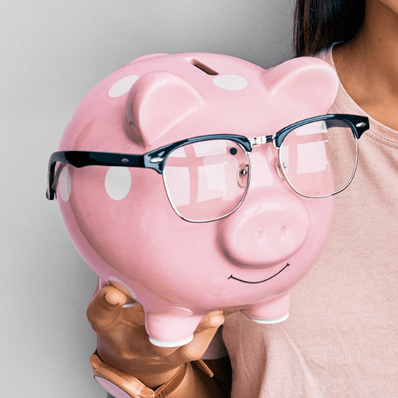 A pink china pig wearing black framed glasses