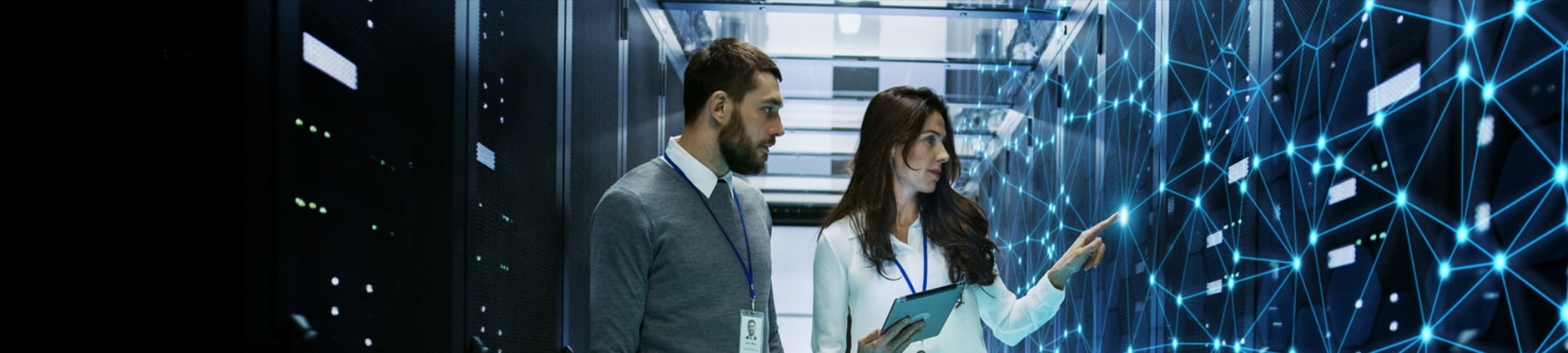 Two employees working in a server room