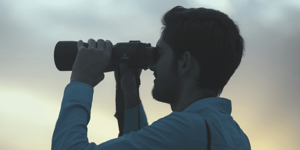 Man looking through binoculars 