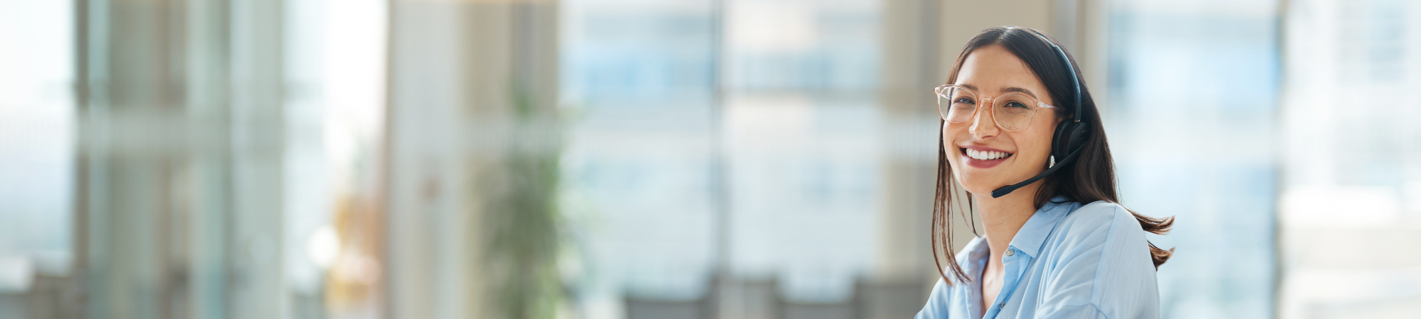 Smiling woman with headset inside Australian call centre