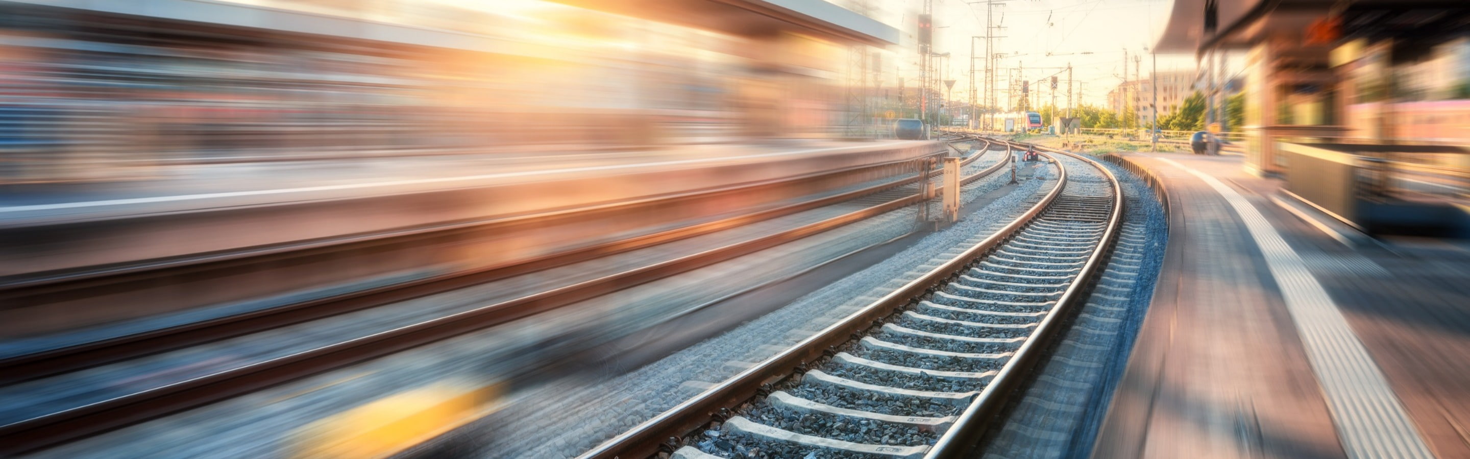 Train zooming by empty railway station