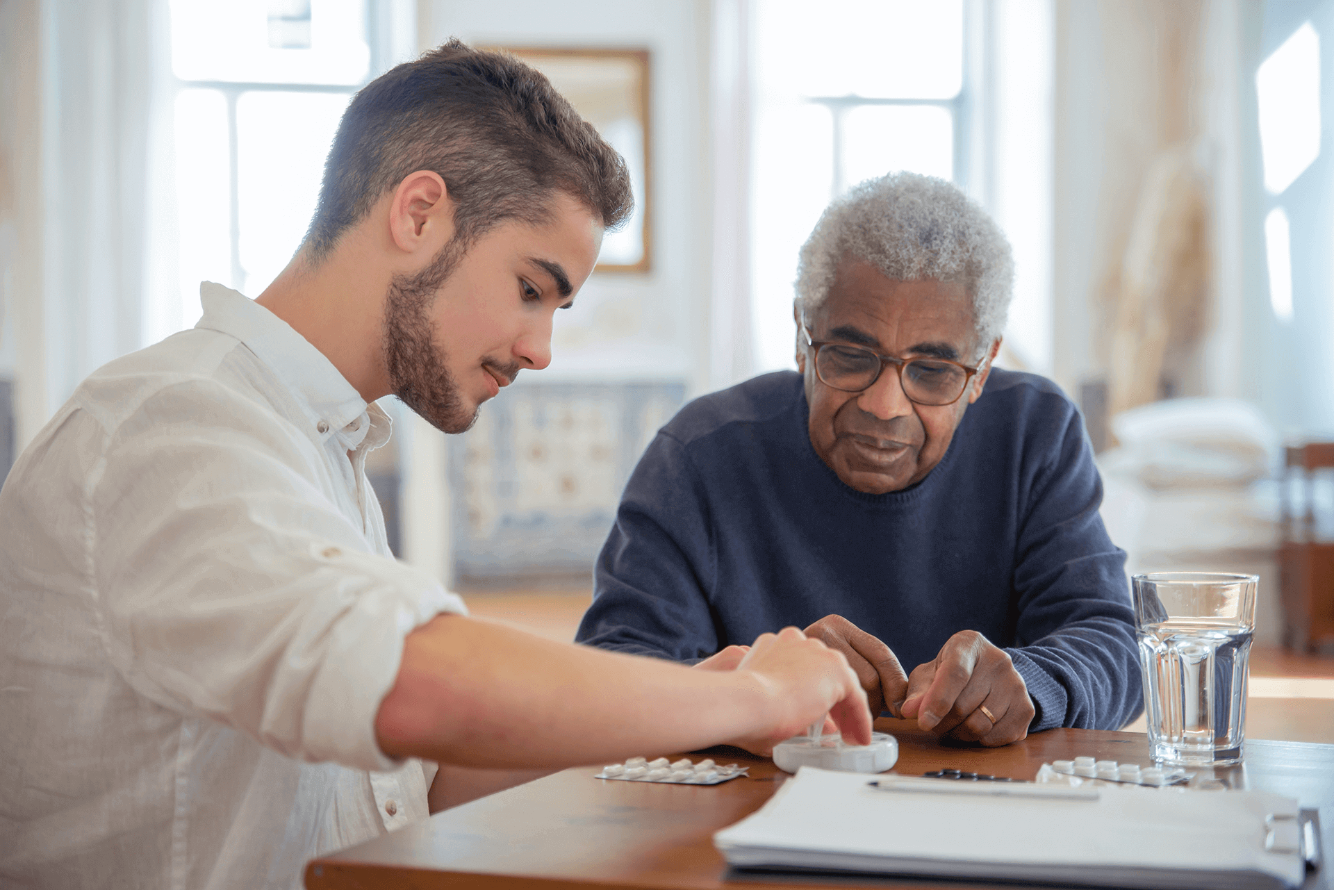 Photograph of Community Worker Helping an Aged Care Resident with Medication